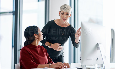 Buy stock photo Shot of a businesswoman helping a colleague in a call centre