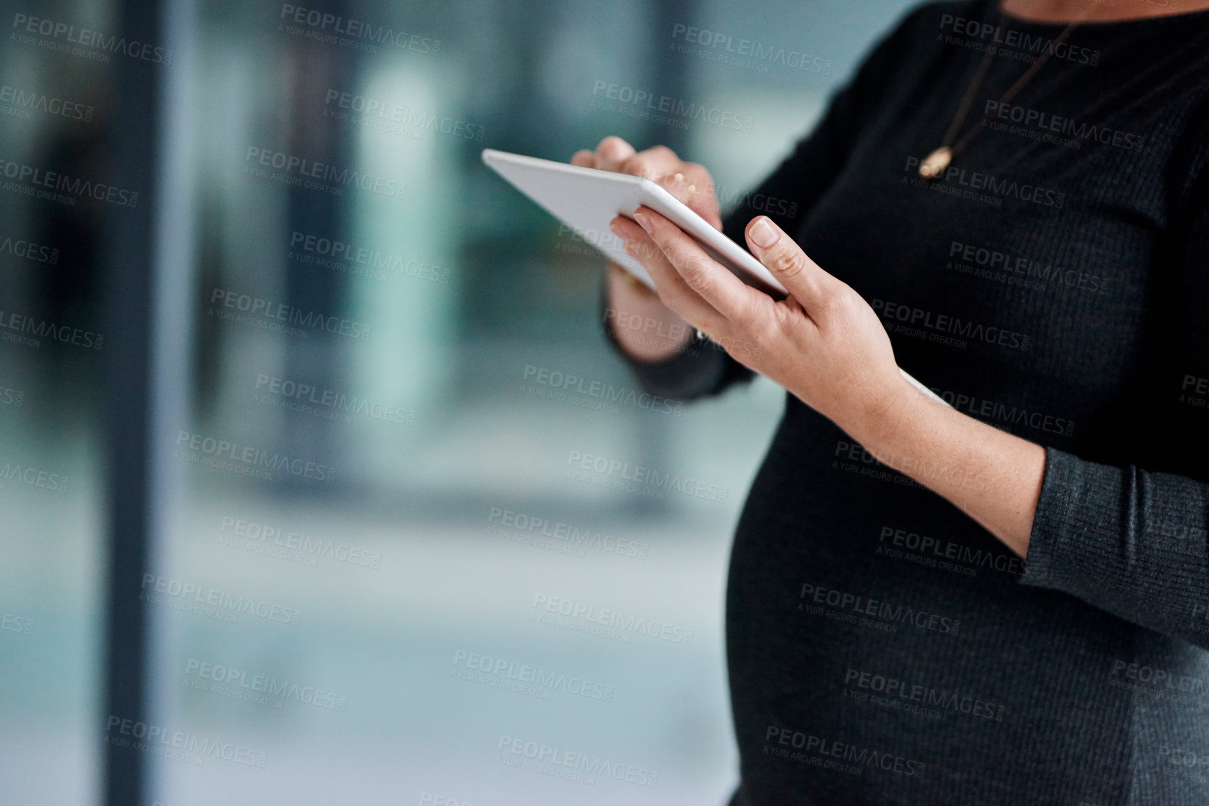 Buy stock photo Closeup shot of a pregnant businesswoman using a digital tablet in an office