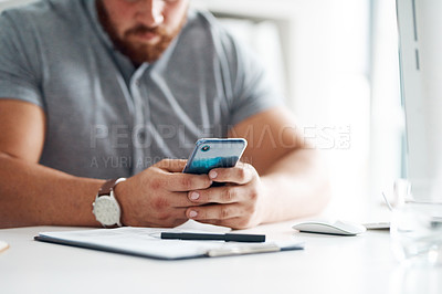 Buy stock photo Closeup shot of an unrecognisable businessman using a cellphone in an office