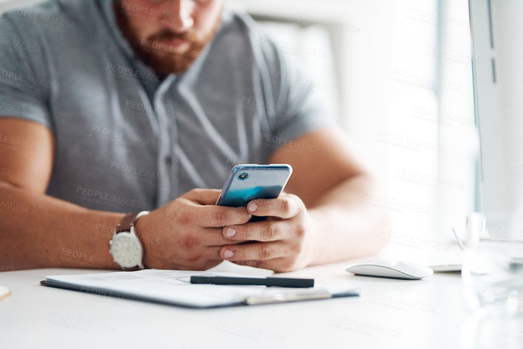 Buy stock photo Closeup shot of an unrecognisable businessman using a cellphone in an office