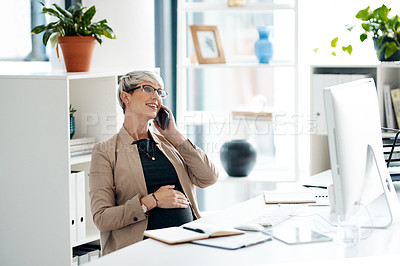 Buy stock photo Shot of a pregnant businesswoman talking on a cellphone in an office