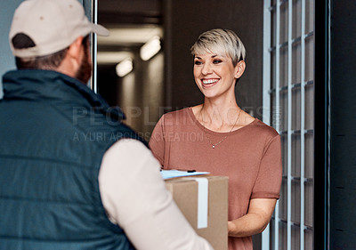 Buy stock photo Shot of a young woman receiving a delivery from the courier
