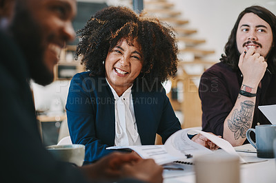 Buy stock photo Shot of a businesswoman looking happy while sitting in the boardroom with colleagues