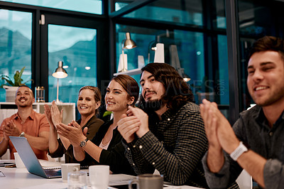 Buy stock photo Shot of a group of businesspeople applauding while sitting in the boardroom