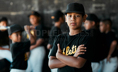 Buy stock photo Portrait of a young baseball player standing with his arms crossed with his teammates standing in the background