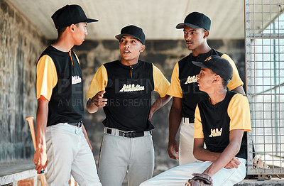 Buy stock photo Shot of a group of young baseball players chatting while standing in the dugout