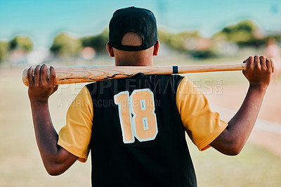 Buy stock photo Rearview shot of a baseball player carrying his bat on his shoulders