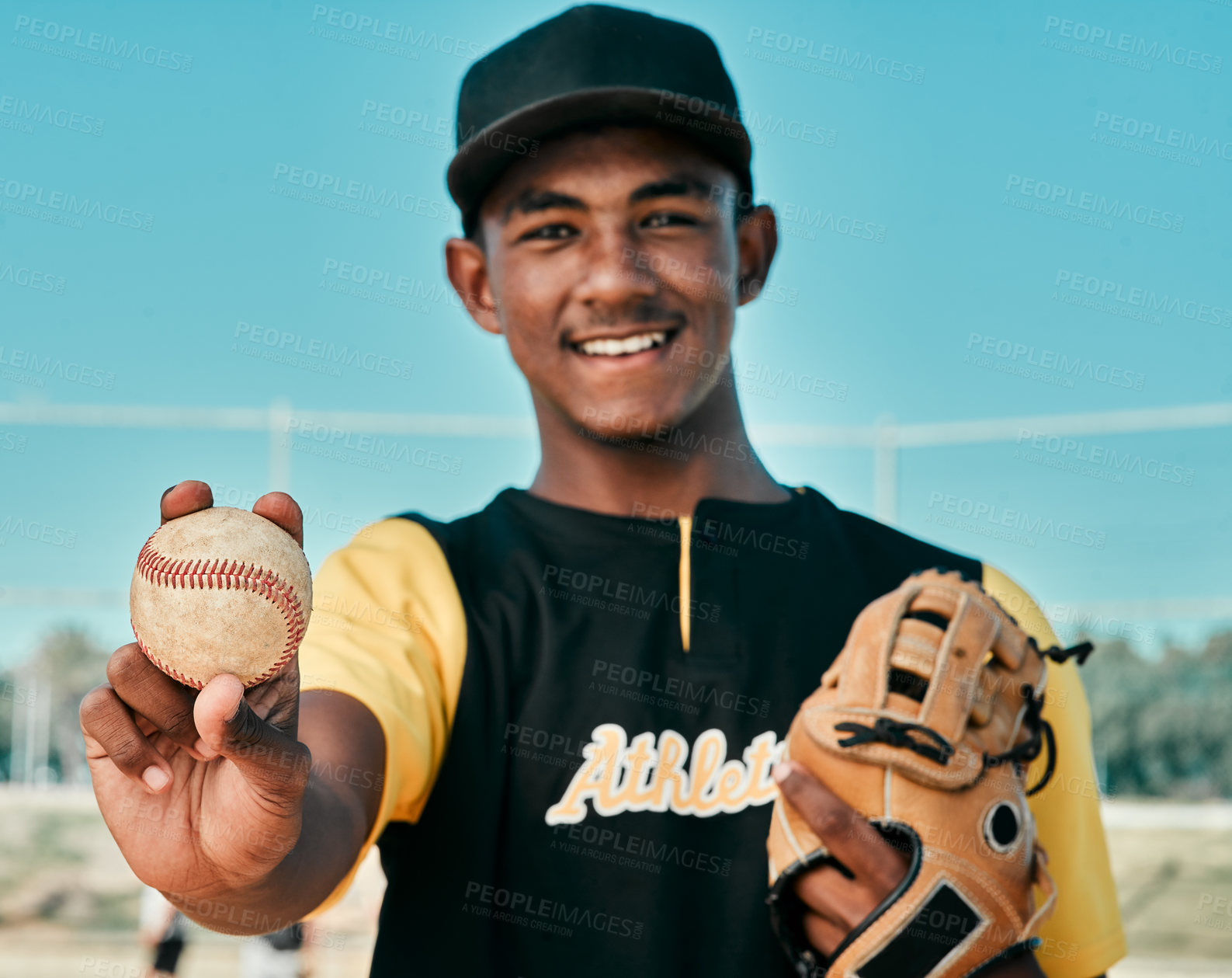 Buy stock photo Shot of a young baseball player wearing a baseball mitt and holding a ball