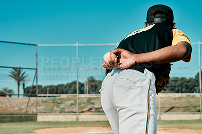 Buy stock photo Rearview shot of a baseball player holding the ball behind his back
