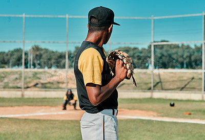 Buy stock photo Shot of a young baseball player getting ready to pitch the ball during a game outdoors