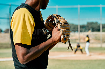 Buy stock photo Shot of a young baseball player getting ready to pitch the ball during a game outdoors