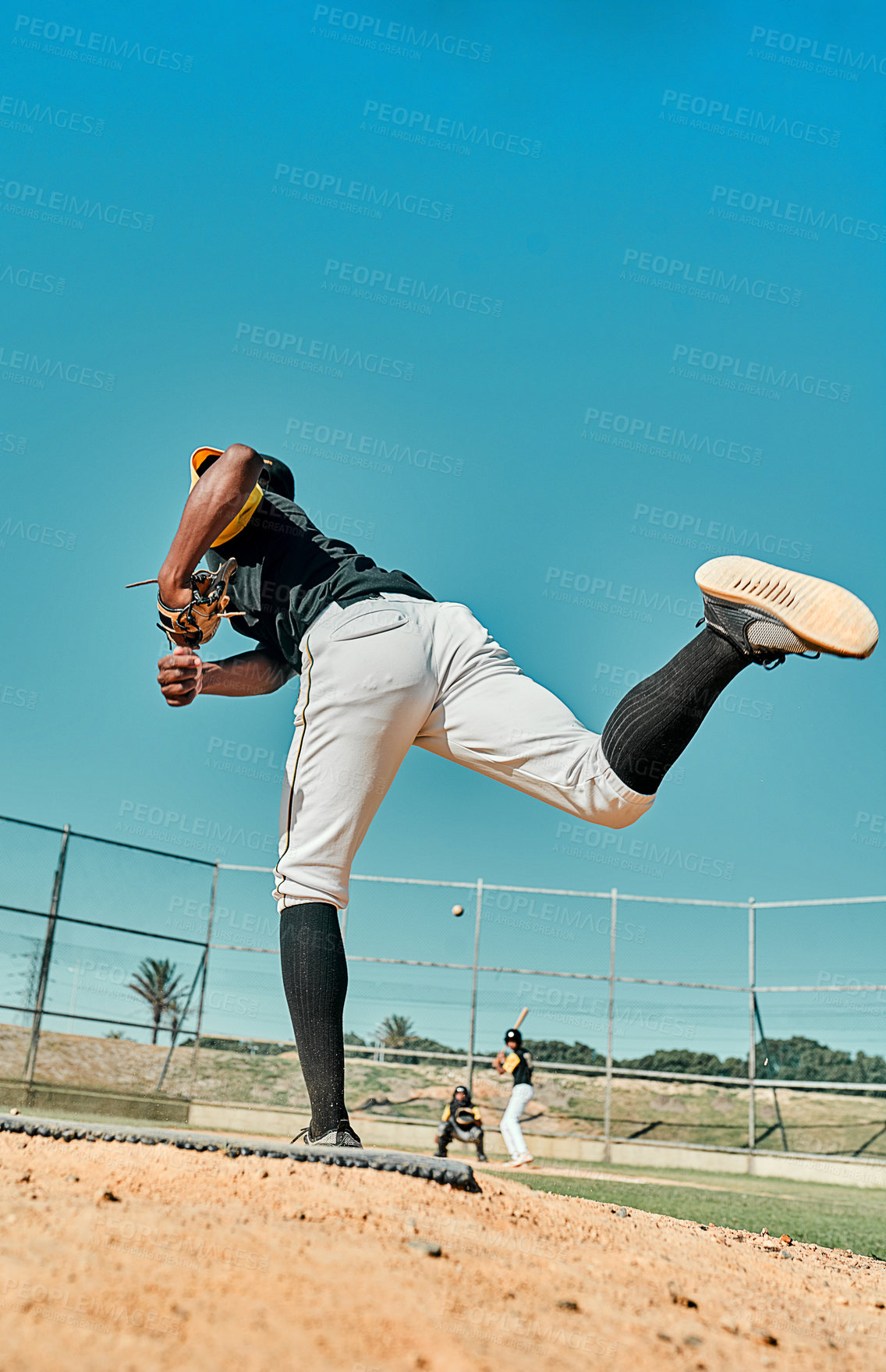 Buy stock photo Shot of a young baseball player pitching the ball during a game outdoors