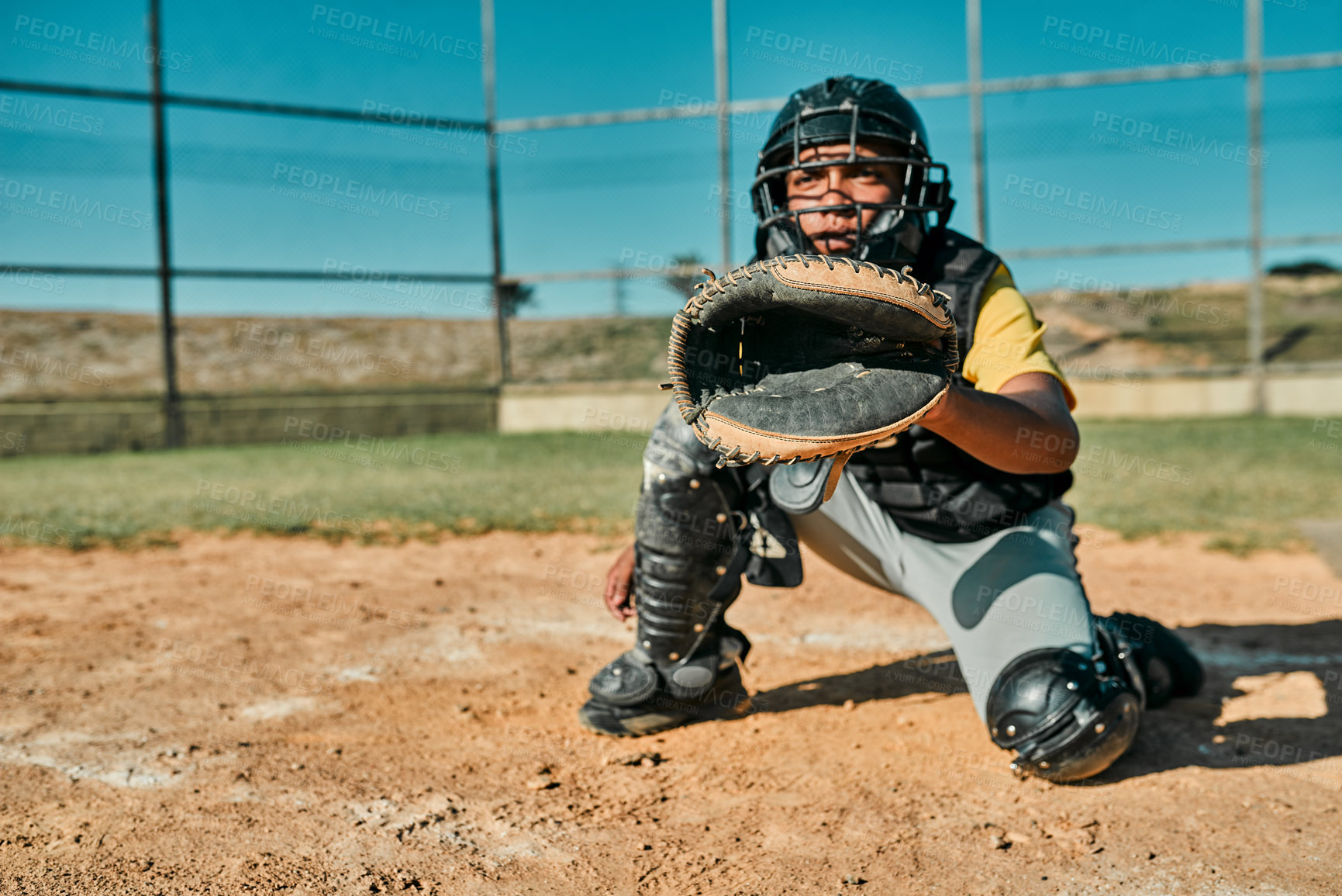 Buy stock photo Shot of the catcher sitting in position to catch the ball