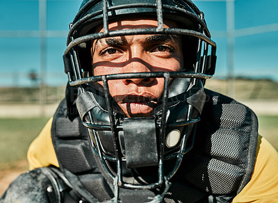 Buy stock photo Shot of a young player wearing a catcher's helmet while playing baseball