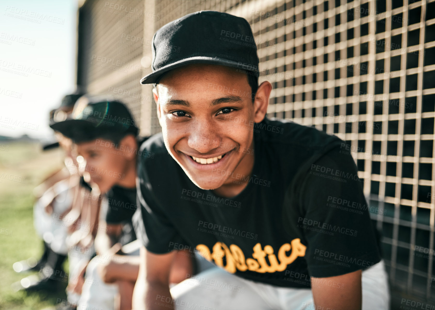 Buy stock photo Portrait of a young baseball player sitting on a baseball field