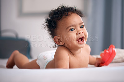 Buy stock photo Shot of an adorable baby boy playing on the bed at home