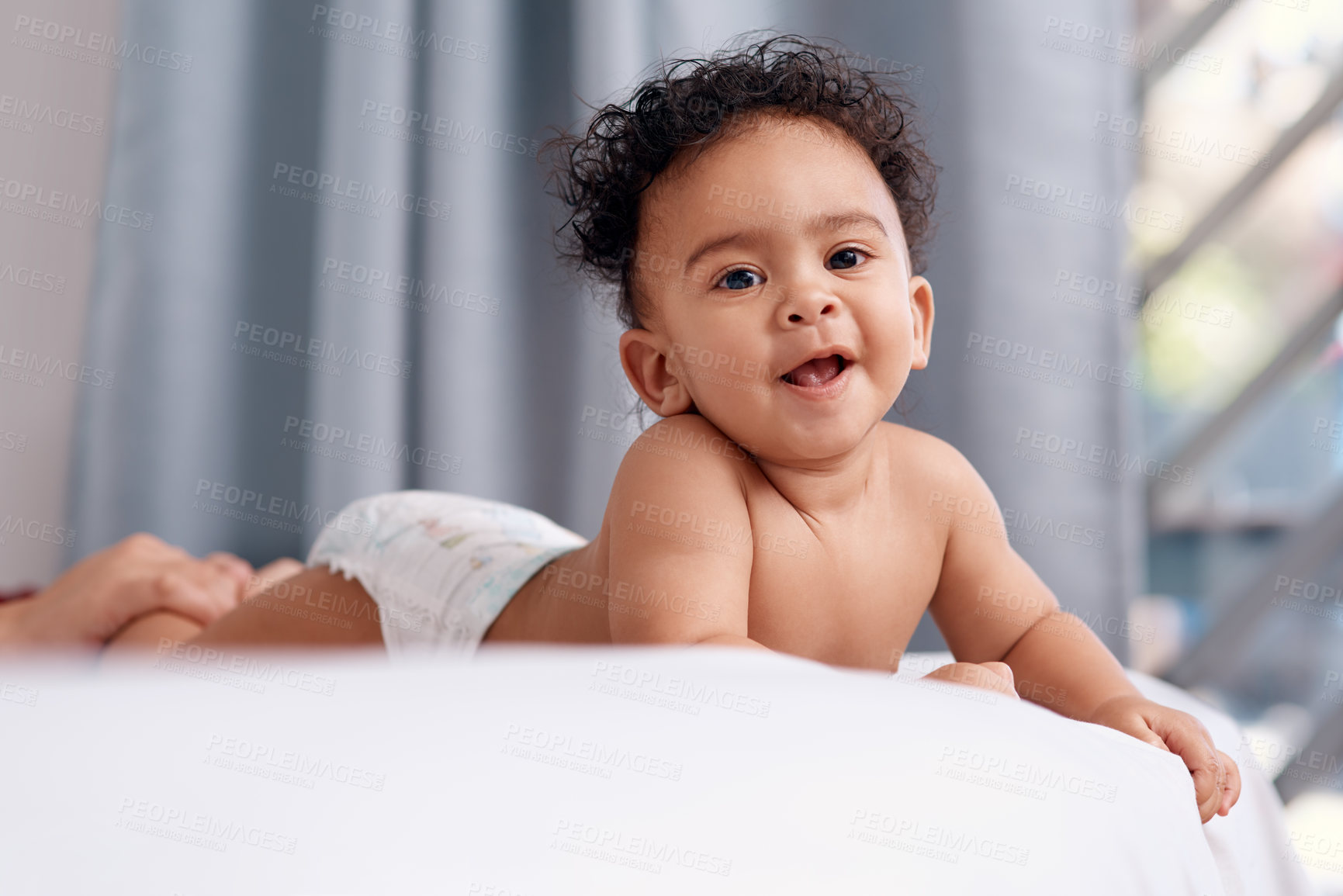 Buy stock photo Shot of an adorable baby boy on the bed at home