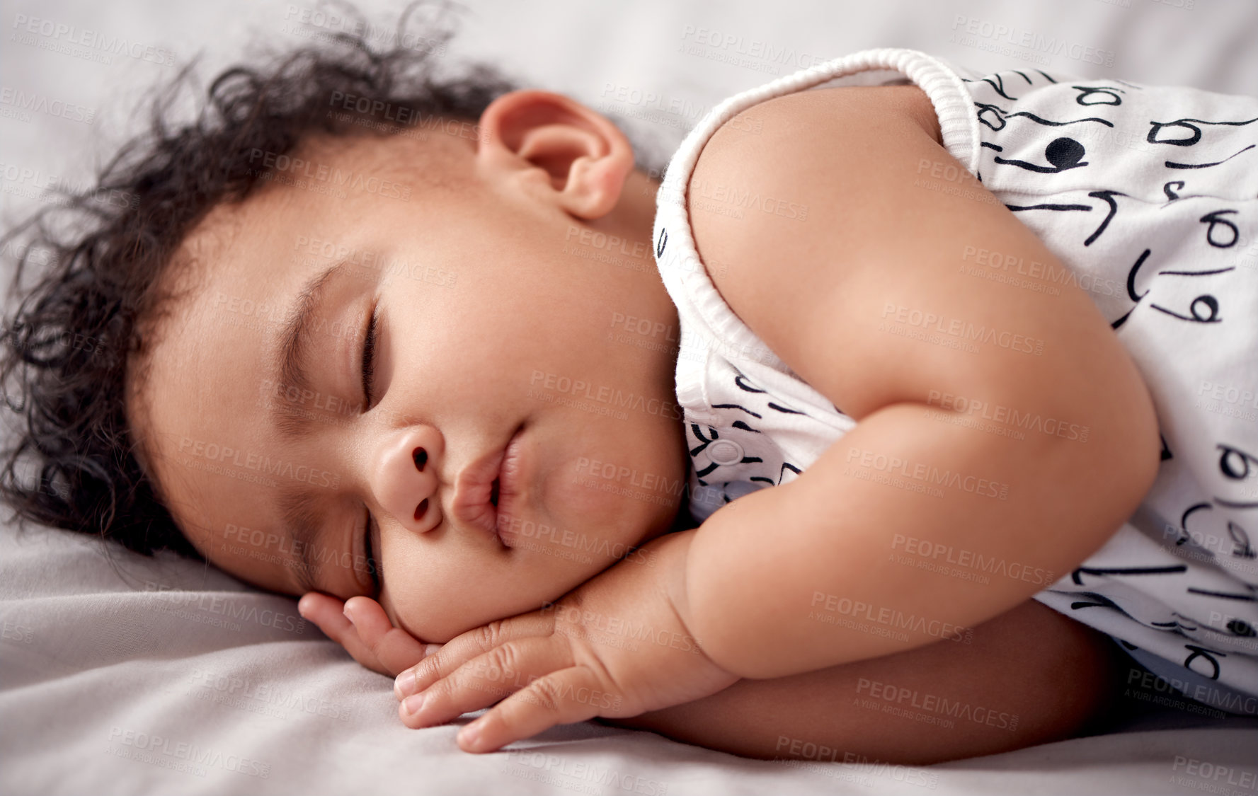 Buy stock photo Shot of an adorable baby boy sleeping peacefully on the bed at home