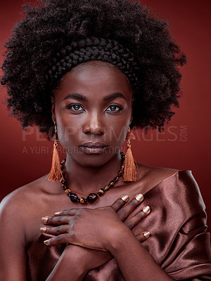 Buy stock photo Portrait, beauty and black woman with traditional fashion in studio isolated on a red background. Natural face, makeup cosmetics and serious African model with stylish outfit, headband and culture.
