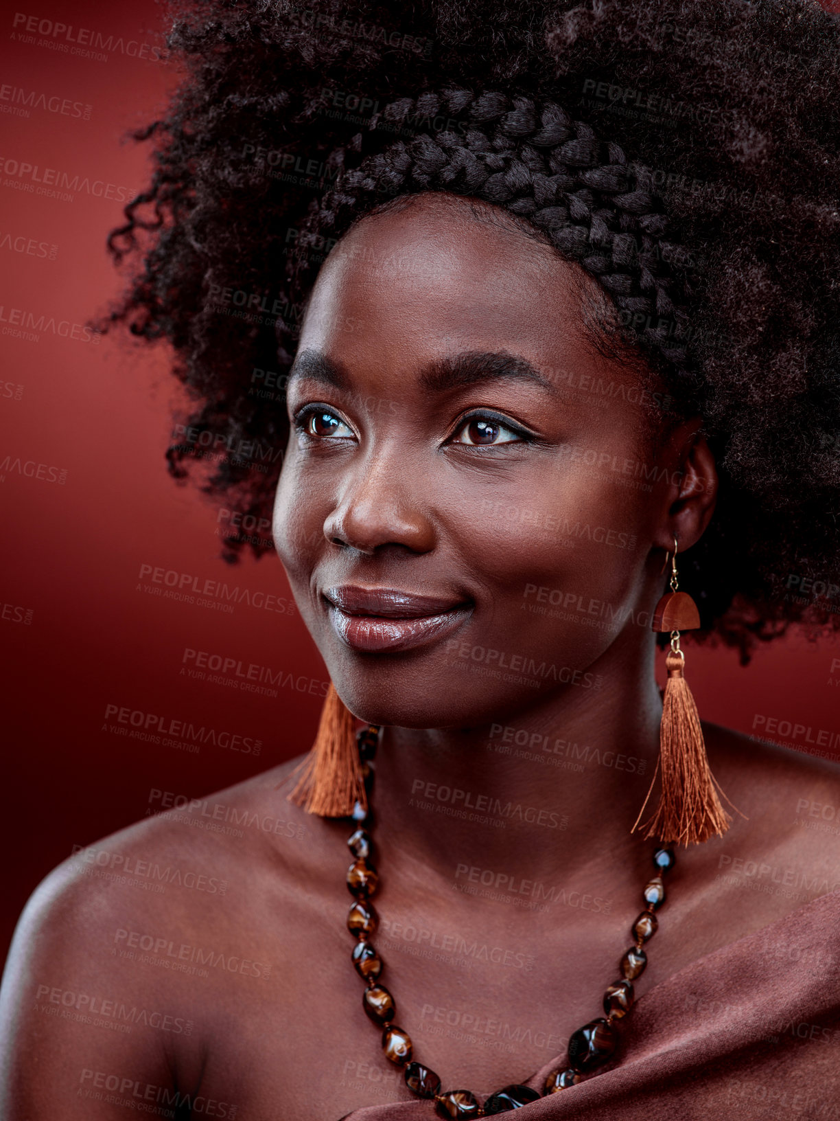 Buy stock photo Cropped shot of a beautiful young woman posing against a red background