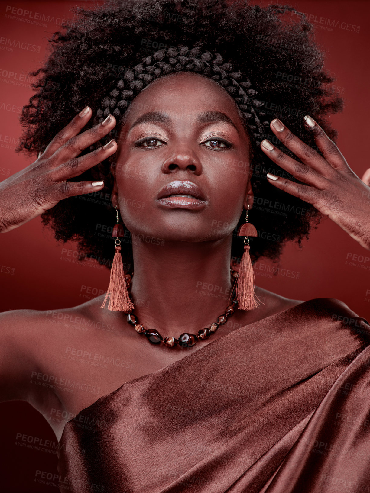 Buy stock photo Portrait, beauty and black woman with fashion in studio isolated on a red background. Face, makeup cosmetics and confident African model with stylish outfit, traditional headband or culture aesthetic