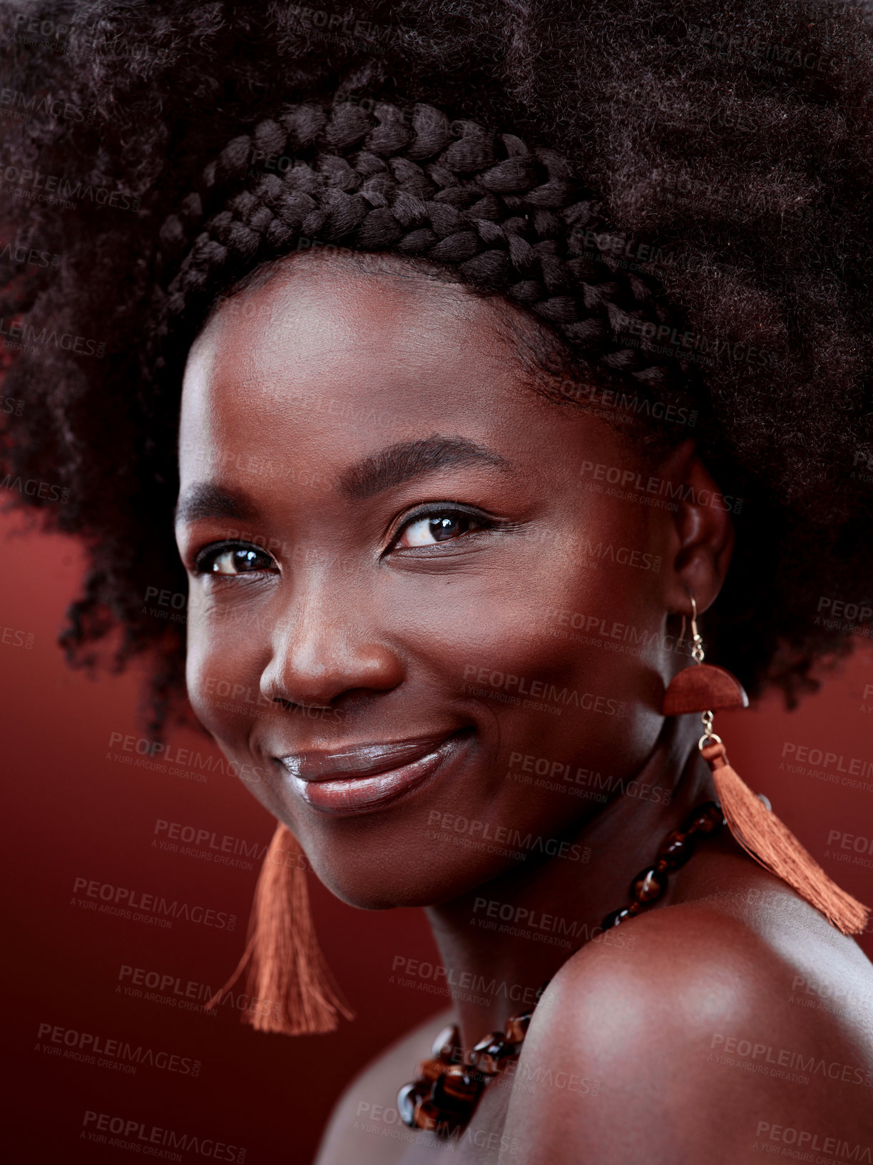 Buy stock photo Cropped portrait of a beautiful young woman posing against a red background