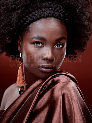 Buy stock photo Face, natural beauty and black woman with fashion in studio isolated on a red background. Portrait, makeup cosmetics and serious African model with stylish outfit, traditional jewelry and aesthetic