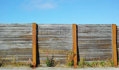 Buy stock photo Old wooden fence outside in a garden at home. The vintage architecture of an enclosure surrounding a house used for privacy, designing, and landscaping to decorate or protect a house with copy space