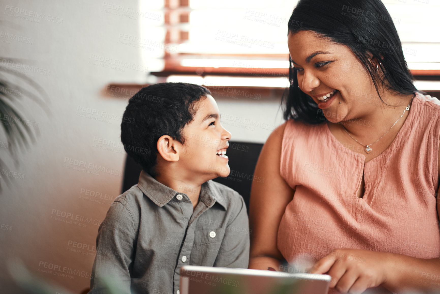 Buy stock photo Shot of a mother and her little son using a digital tablet together at home