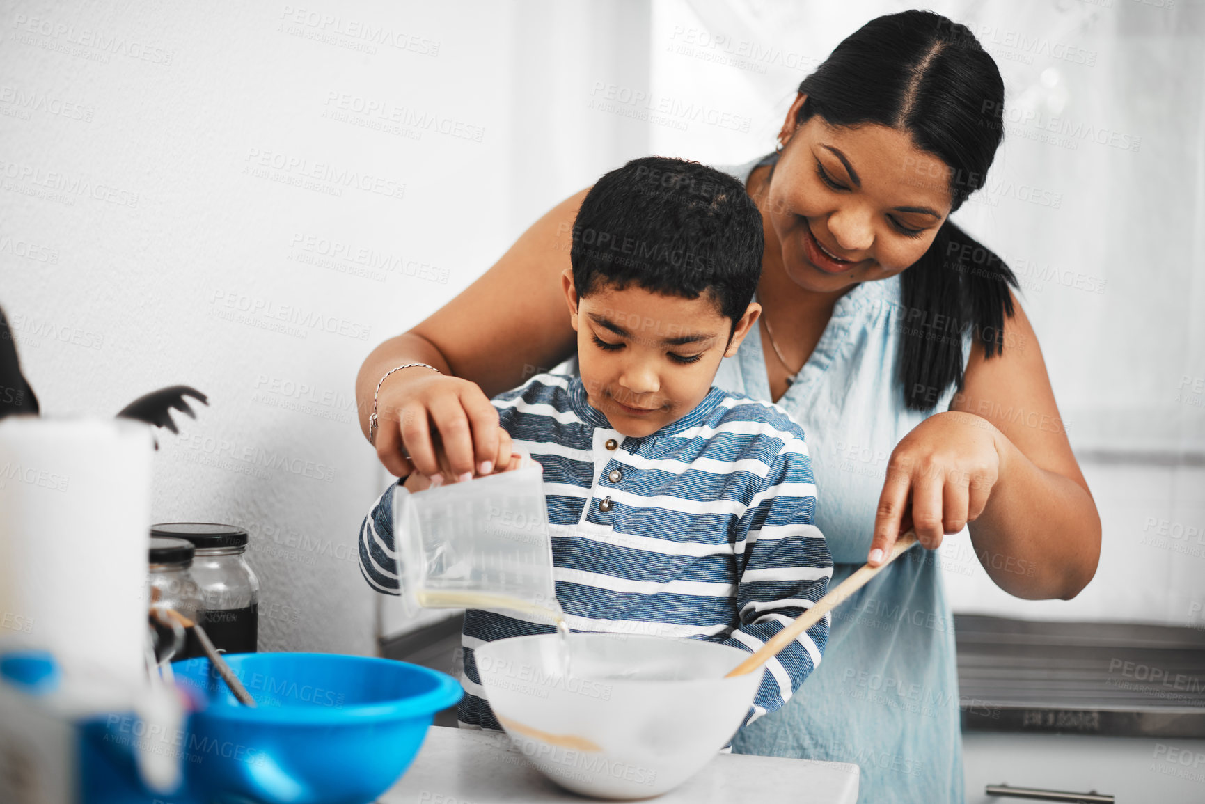 Buy stock photo Mother, boy and baking in house with spoon for learning, teaching and cake as bonding by helping. Mom, son and cooking in home with bowl for support, development and food or fun as thanksgiving lunch