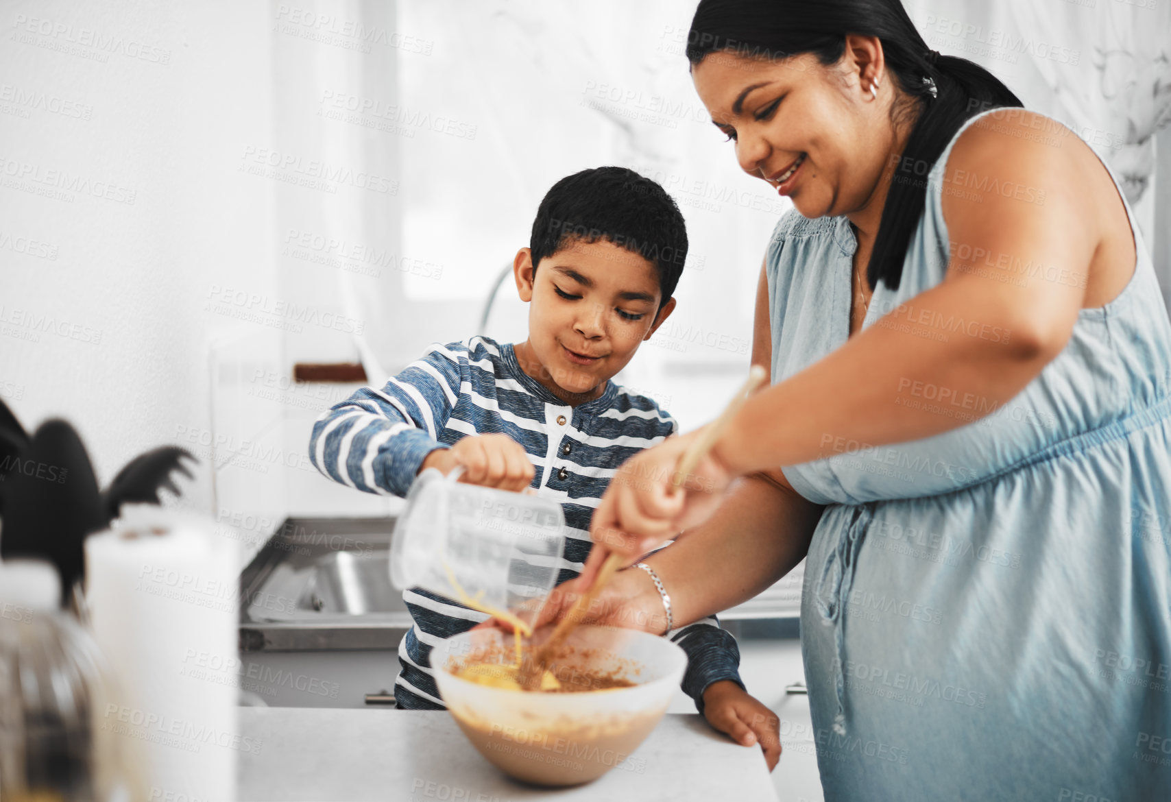 Buy stock photo Shot of a mother and her little son baking together at home