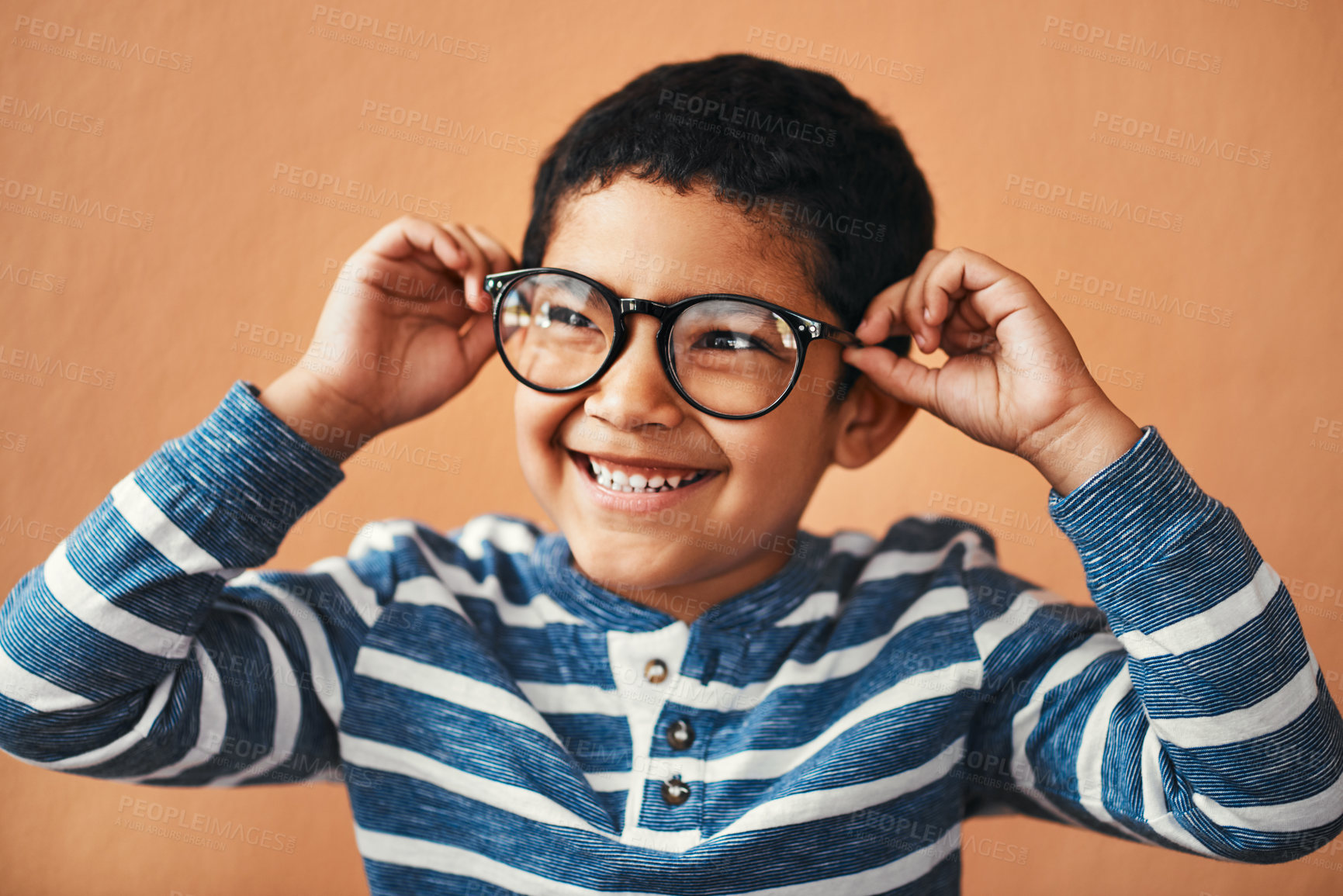 Buy stock photo Happy boy, glasses and fashion with sight for vision, eye care or optometry in youth on a wall background. Young male person, nerd child or geek kid with smile for casual eyewear or smart spectacles