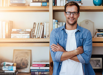 Buy stock photo Cropped portrait of a handsome man standing with his arms crossed at home