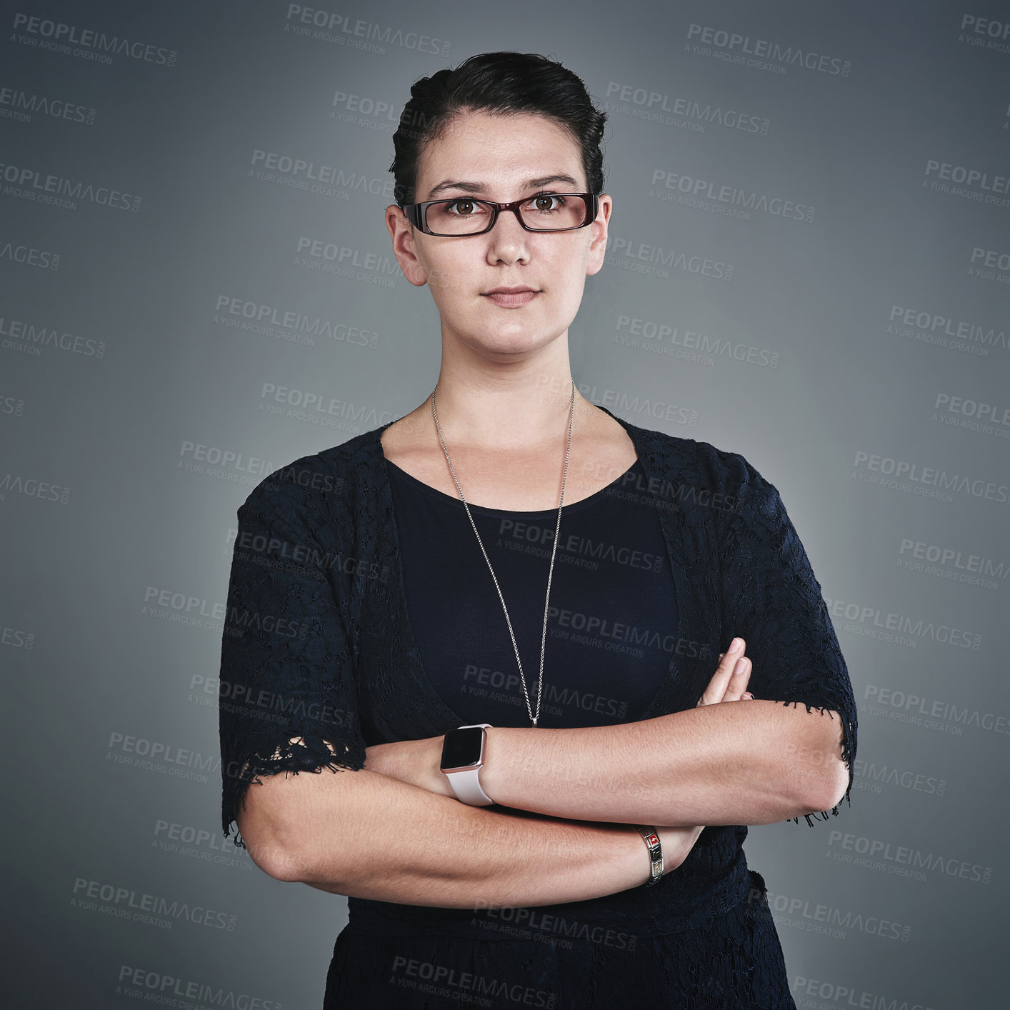 Buy stock photo Studio portrait of a confident young businesswoman posing against a grey background