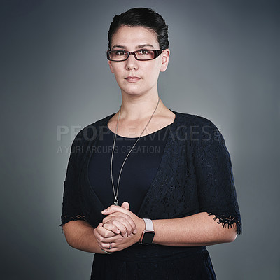Buy stock photo Studio portrait of a confident young businesswoman posing against a grey background