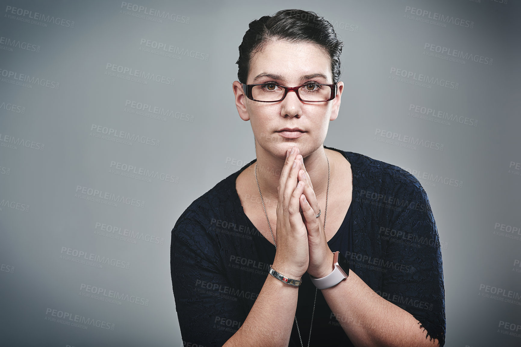 Buy stock photo Studio portrait of a confident young businesswoman posing against a grey background