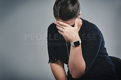 Buy stock photo Studio shot of a young businesswoman looking sad against a gray background