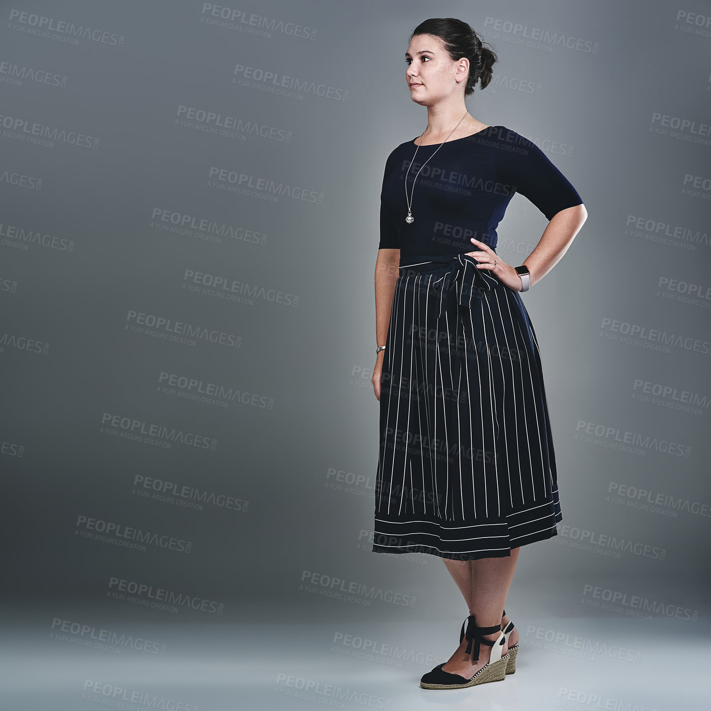 Buy stock photo Studio shot of a confident young businesswoman posing against a grey background