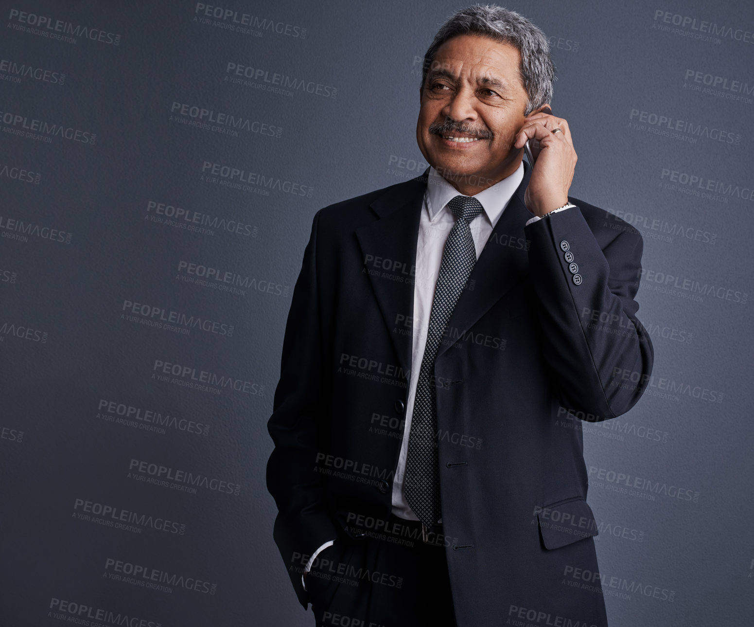 Buy stock photo Studio shot of a mature businessman talking on his cellphone