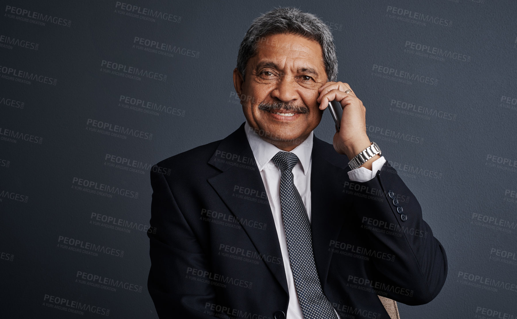 Buy stock photo Studio shot of a mature businessman talking on his cellphone