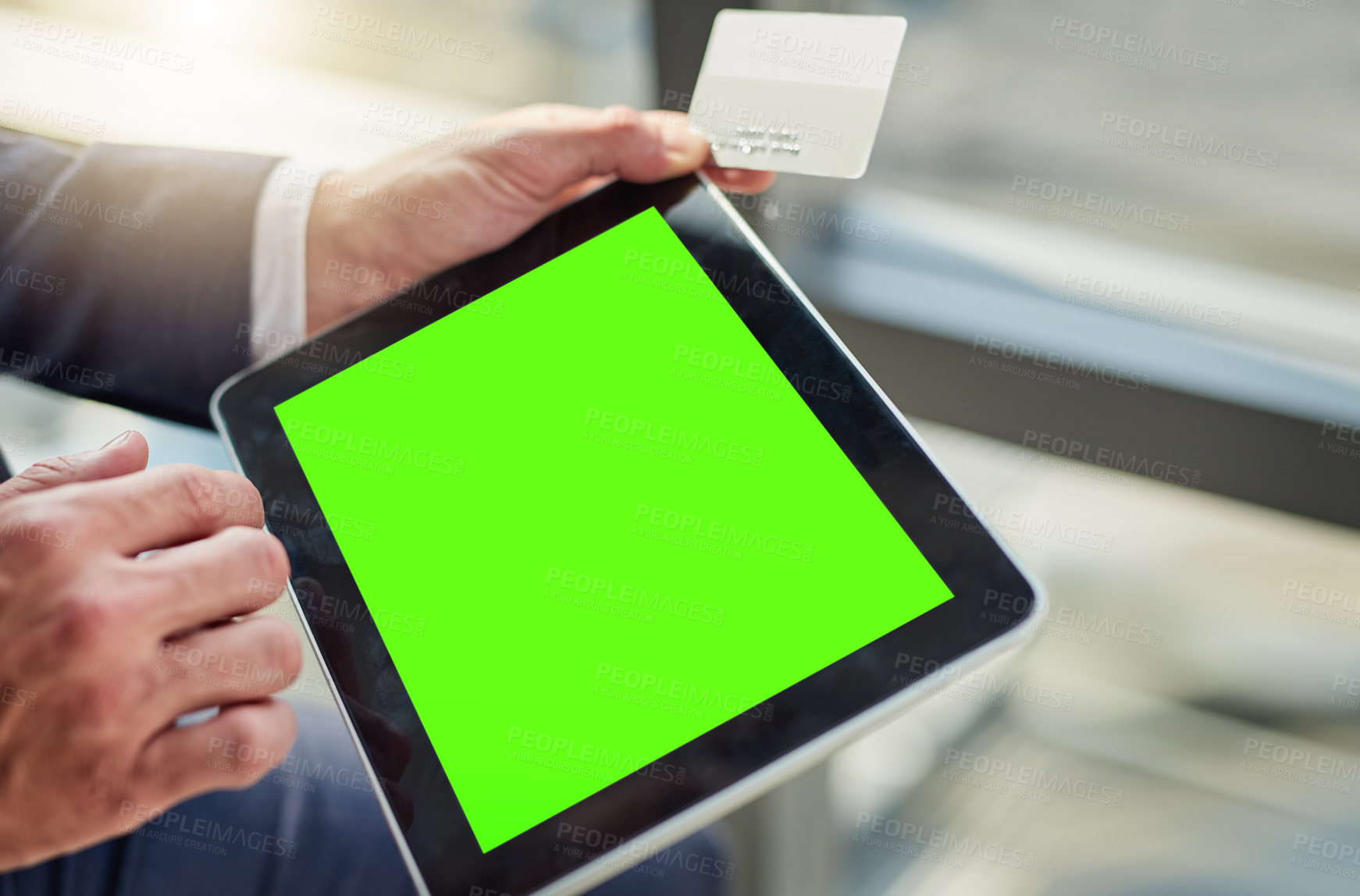 Buy stock photo Cropped shot of an unrecognizable businessman using a digital tablet with a green screen in a modern office
