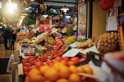 Buy stock photo Shot of a bunch of market stalls placed next to each other selling fruit at a market during the day