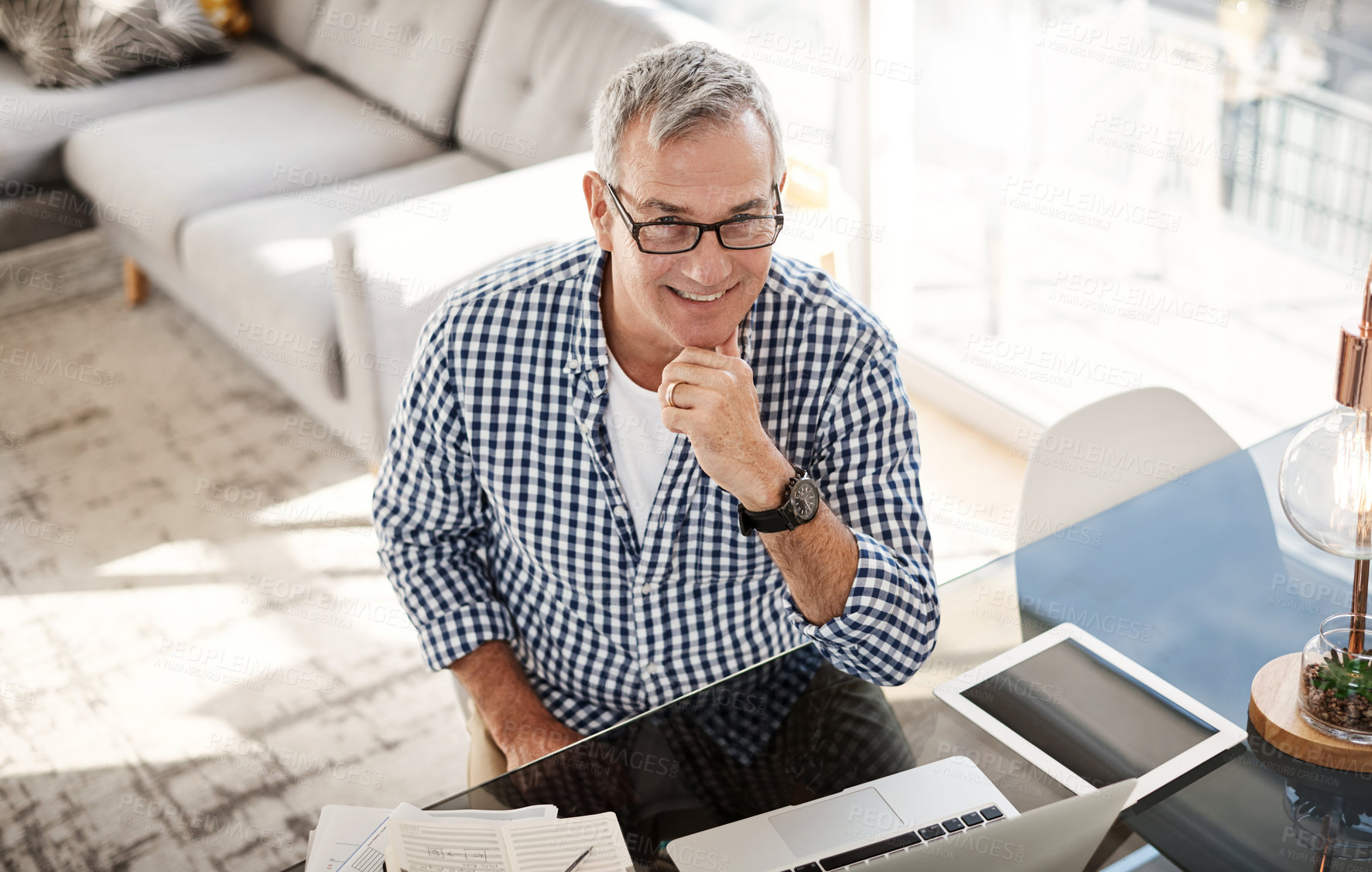 Buy stock photo Portrait of a mature man working on a laptop at home