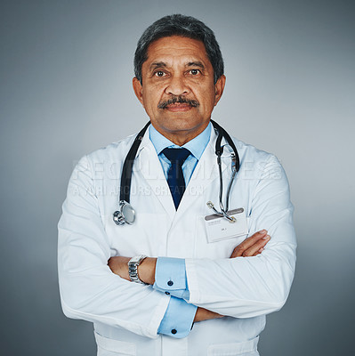 Buy stock photo Studio portrait of a confident mature doctor against a gray background