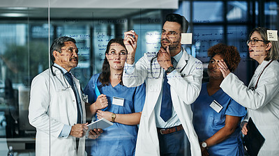 Buy stock photo Shot of a team of doctors having a brainstorming session in a hospital