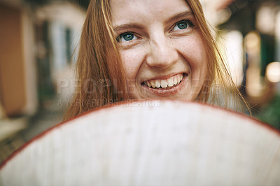 Buy stock photo Cropped shot of a woman holding a conical hat in front of her face