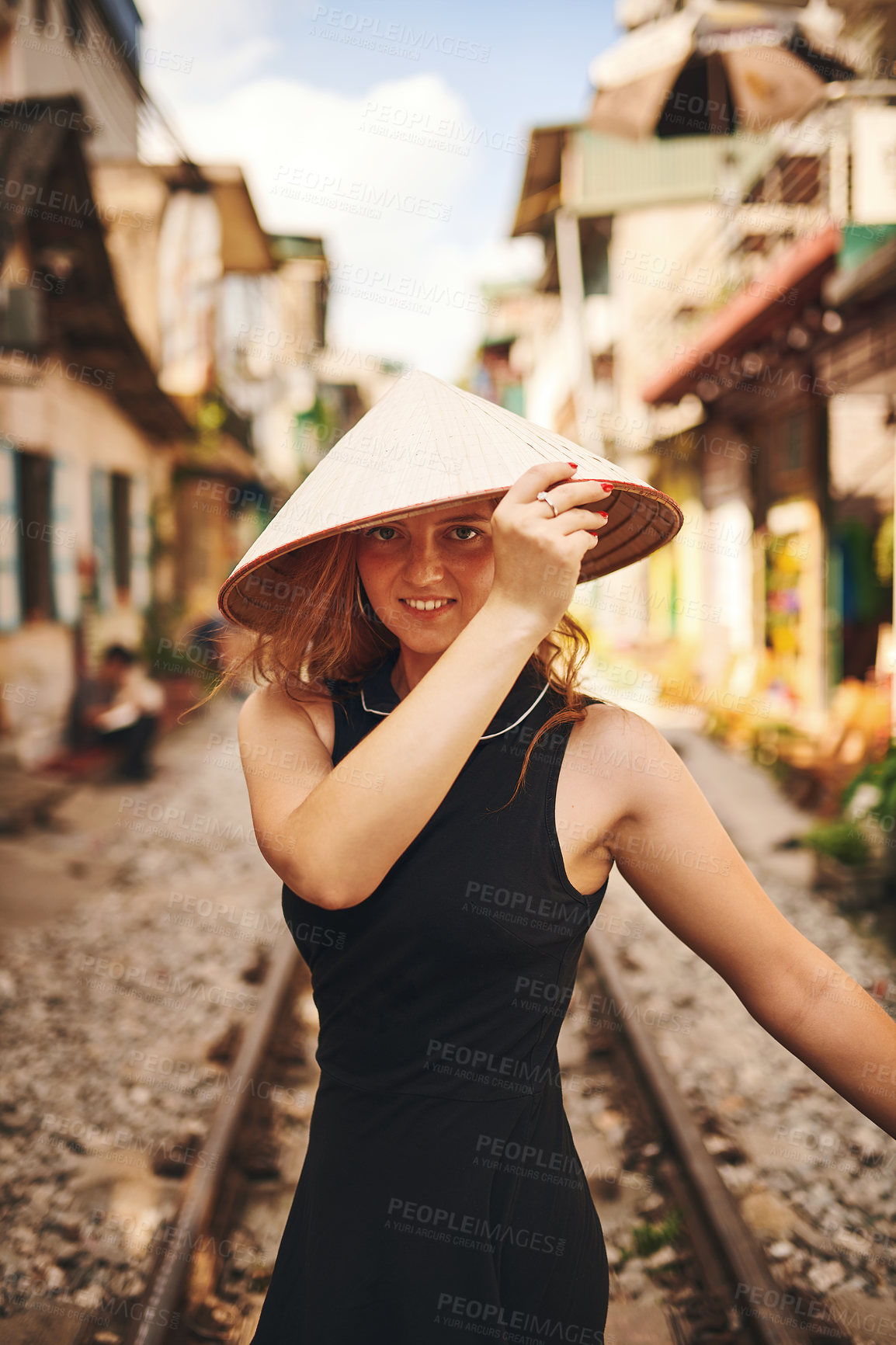 Buy stock photo Travel, fashion and portrait of woman on train tracks in city for holiday, vacation and tourist destination in Vietnam. Happy, hat and person by railway for adventure, journey and explore urban town