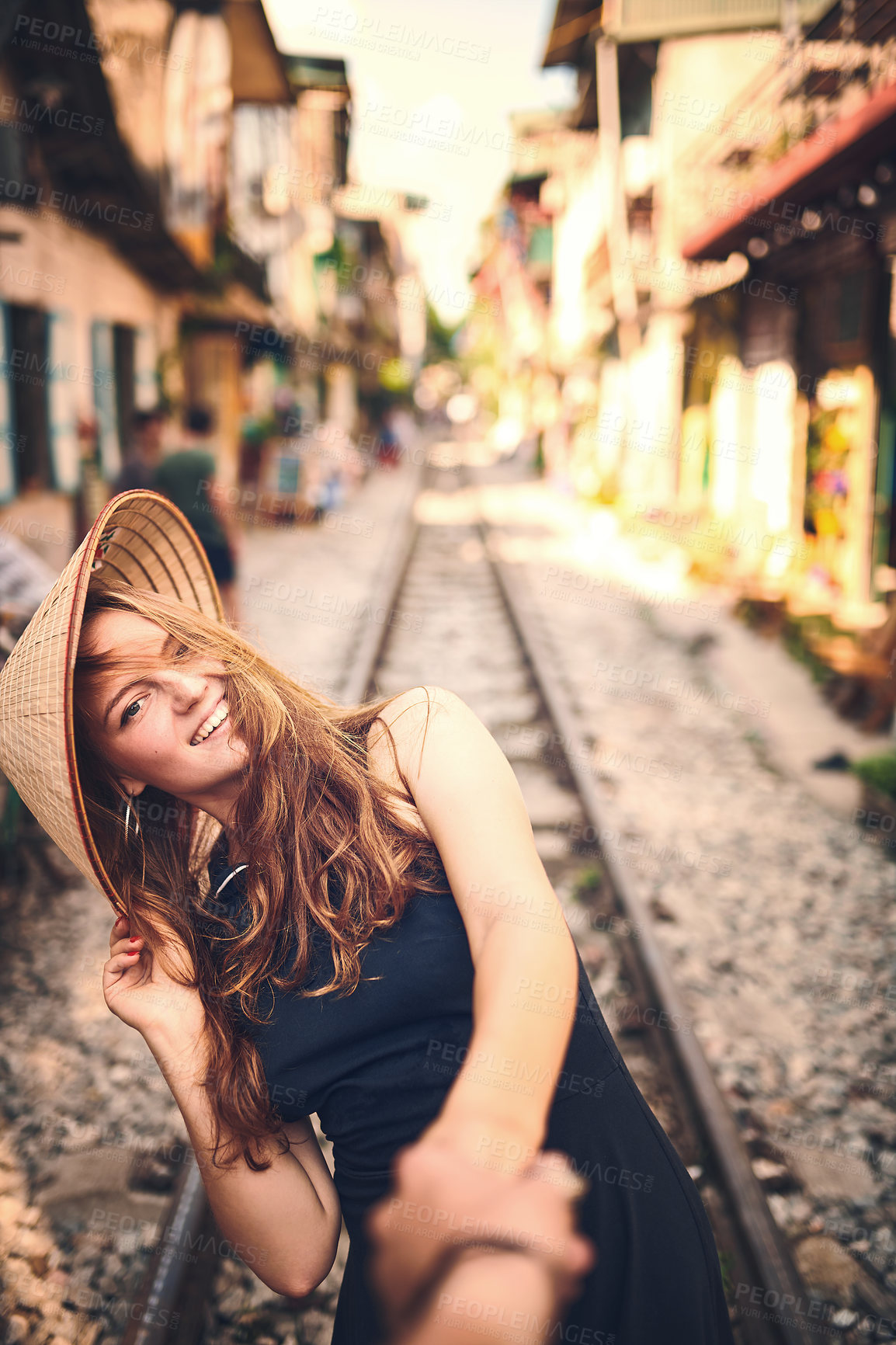 Buy stock photo Travel, holding hands and portrait of woman on train tracks in Vietnam city for holiday, vacation and tourist destination. Happy, couple pov and girl on railway for adventure, journey and sightseeing