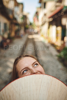 Buy stock photo Cropped shot of a woman holding a conical hat in front of her face