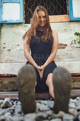 Buy stock photo Shot of a young woman sitting outside while exploring a foreign city